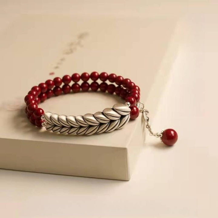 Abundant Harvest Wheat Sheaf Cinnabar Bracelet - Protection &amp; Prosperity - close-up prop-styled shot focus on wheat motif