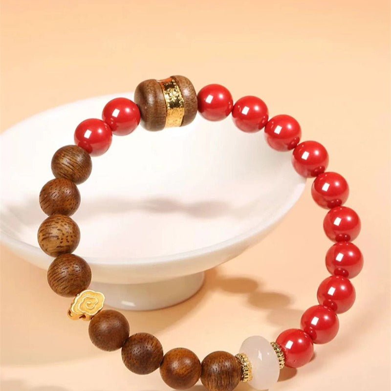 Auspicious Clouds & Blessings Bracelet - Peace & Good Fortune - prop-styled shot with cinnabar and agarwood main beads