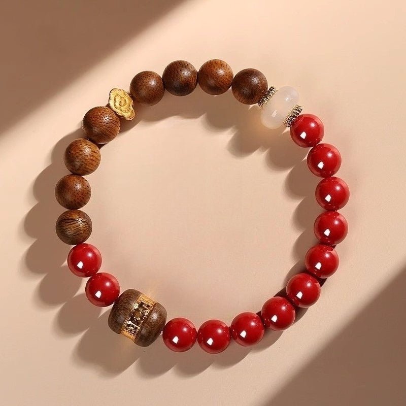 Auspicious Clouds & Blessings Bracelet - Peace & Good Fortune - top view staged shot with cinnabar and agarwood main beads