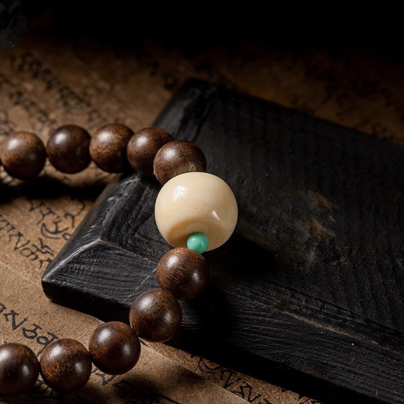 Black Sandalwood Bead Bracelet With Engraved Buddha Charm - Peace &amp; Grounding - Close up of Mother bead