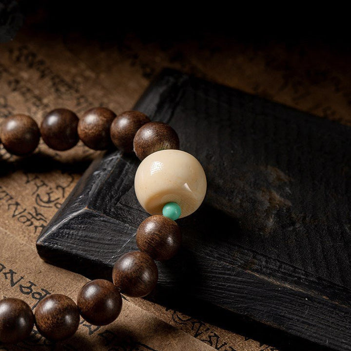 Black Sandalwood Bead Bracelet With Engraved Buddha Charm - Peace &amp; Grounding - Close up of Mother bead