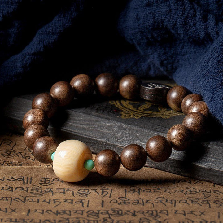 Black Sandalwood Bead Bracelet With Engraved Buddha Charm - Peace &amp; Grounding - Prop Styling