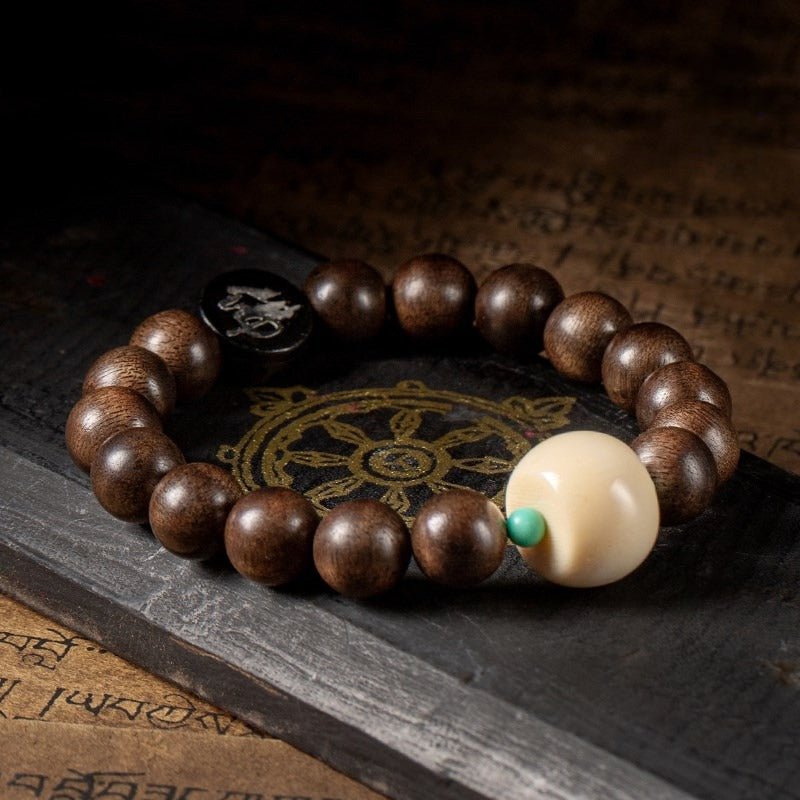 Black Sandalwood Bead Bracelet With Engraved Buddha Charm - Peace & Grounding - Staged Shot