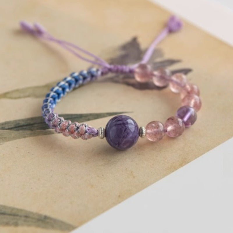 Calm Connection Braided Charm Bracelet - Good Fortune & Harmony -  Prop styling shot of strawberry quartz braid bracelet