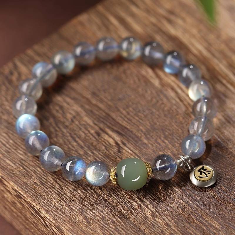 Calm Guardian Chinese Zodiac Buddha Charm Bracelet - Top view staged shot of white crystal and jade bracelet