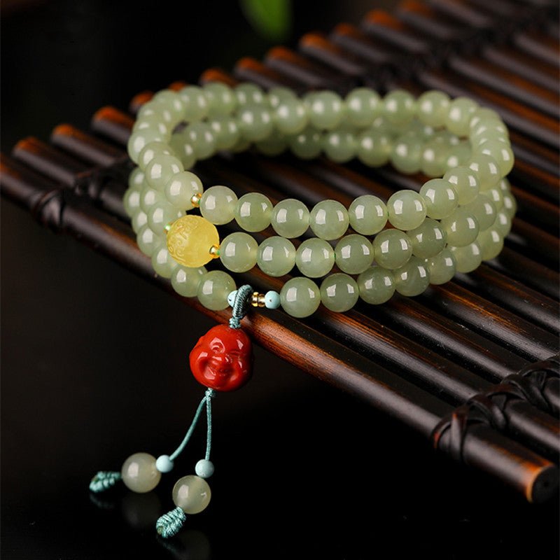 Celadon Jade & Beeswax Amber Tri-Wrap Bracelet With Laughing Buddha Charm - staged shot