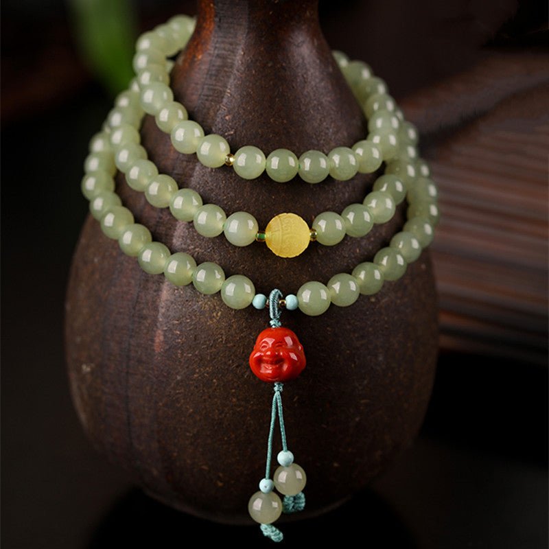 Celadon Jade & Beeswax Amber Tri-Wrap Bracelet With Laughing Buddha Charm - prop styling shot