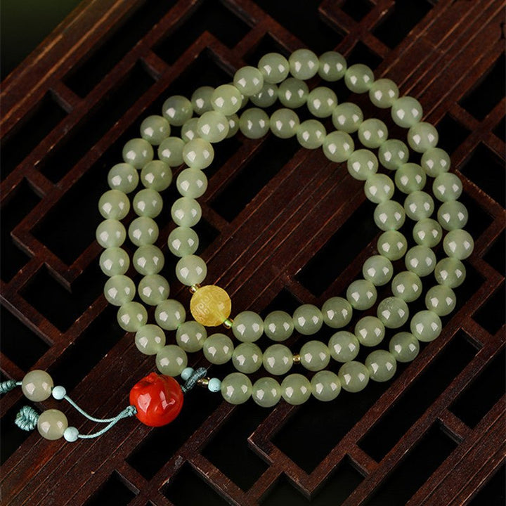 Celadon Jade &amp; Beeswax Amber Tri-Wrap Bracelet With Laughing Buddha Charm - top view shot