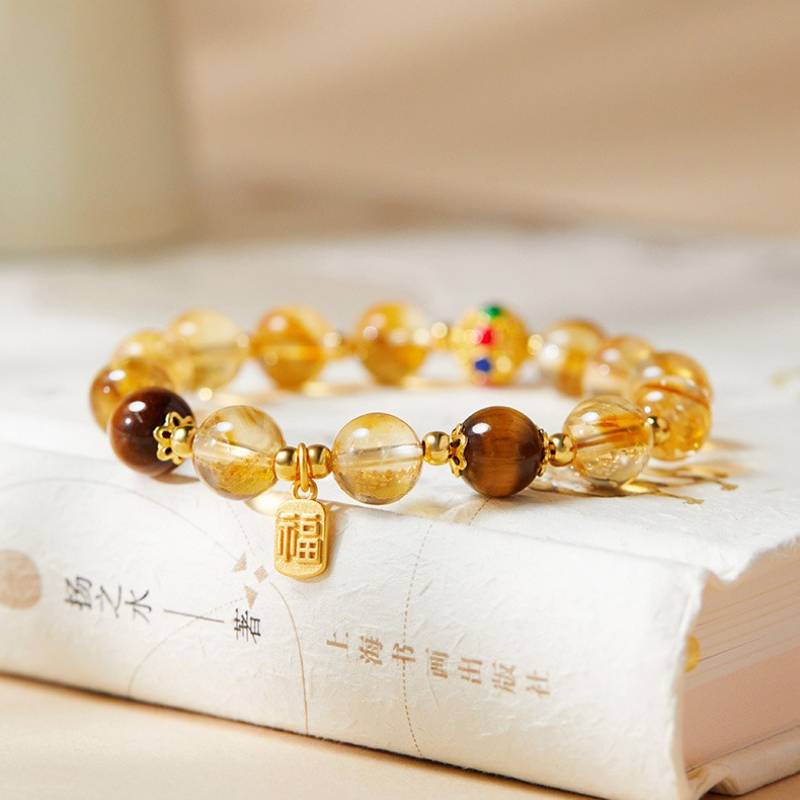 Citrine Luck &amp; Fortune Bracelet - Abundance • Confidence • Flow - prop-styled shot focus on charm