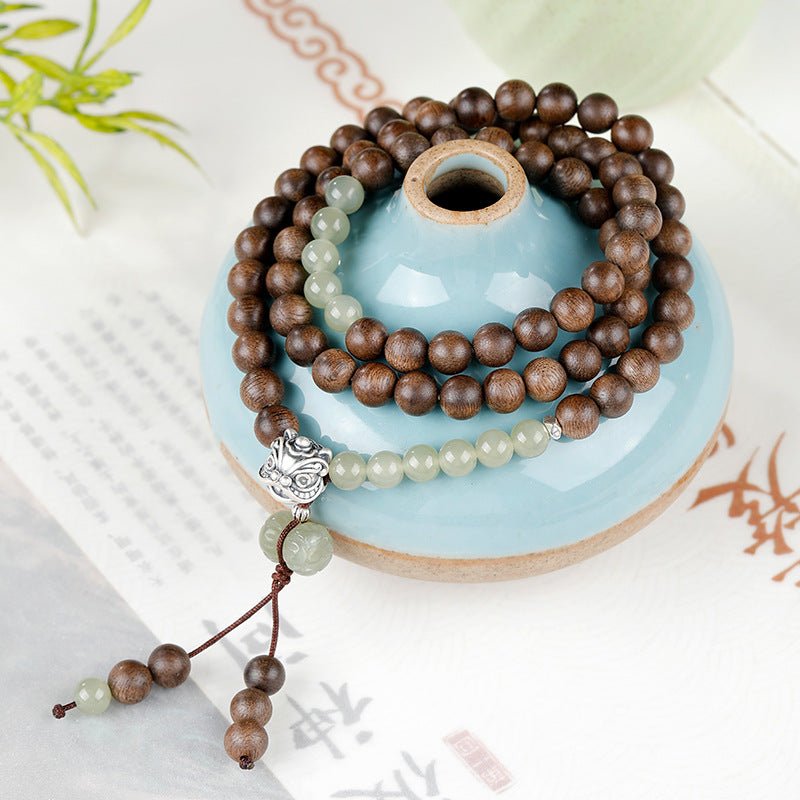 Courage and Fortune Lion Dance Charm Agarwood Bracelet - Serenity & Joy - Arranged with vintage ceramic vessels