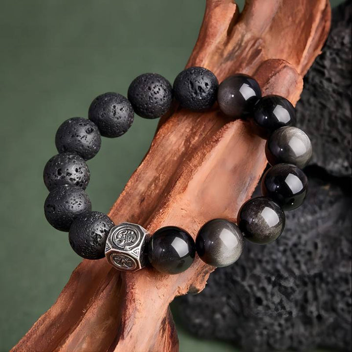 Ember Core Rebirth Bracelet - Resilience • Transformation - Prop styling shot of black obsidian and volcanic stone bracelet