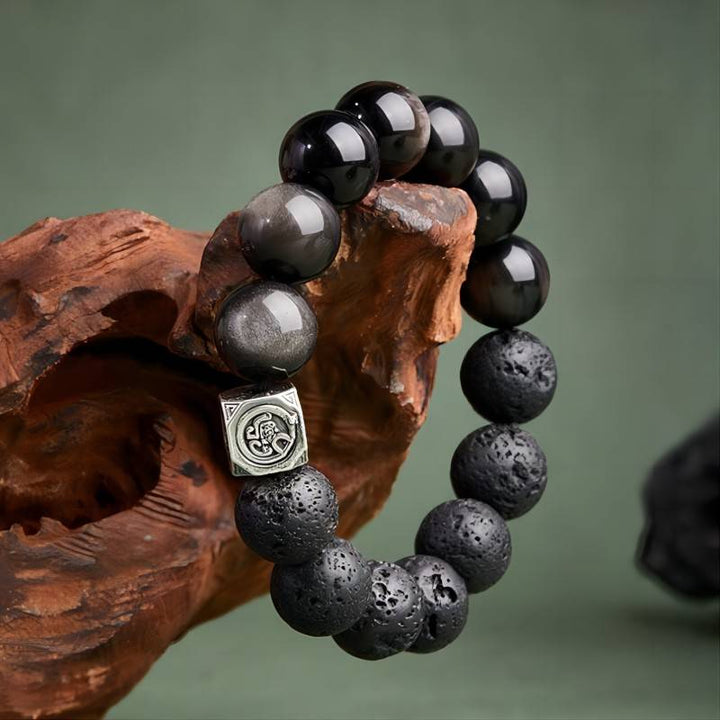 Ember Core Rebirth Bracelet - Resilience • Transformation - On hand shot of black obsidian and volcanic stone bracelet