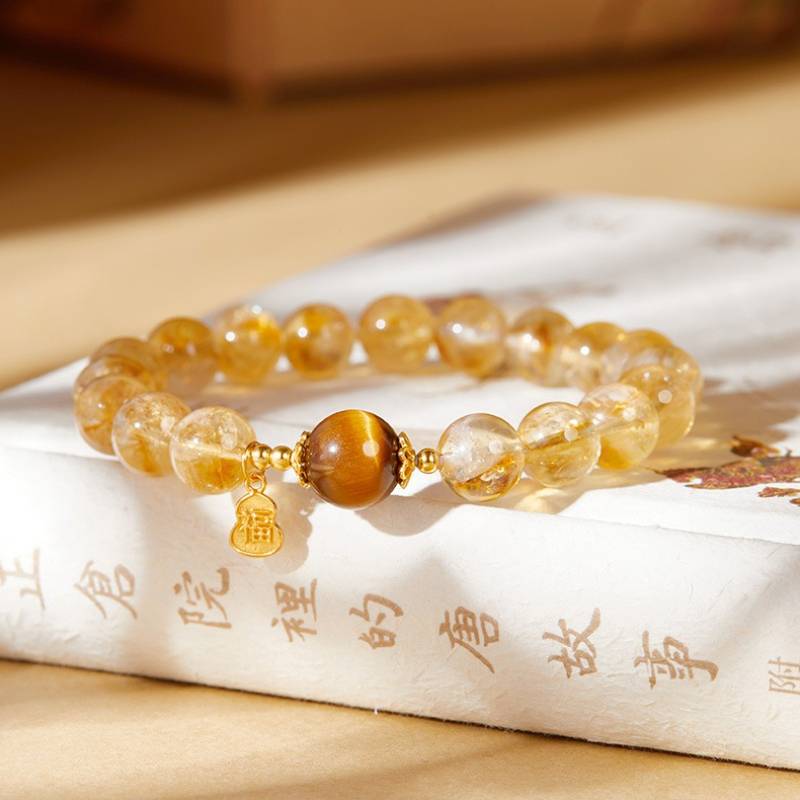 Golden Citrine & Tiger Eye Bracelet With Blessing Charm - staged shot focus on tiger eye master bead