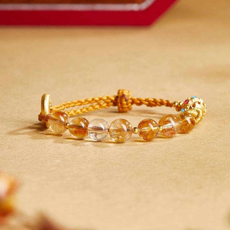 Golden Prosperity Knot Citrine Braided Cord Bracelet With Peace Buckle - staged shot focus on citrine main beads