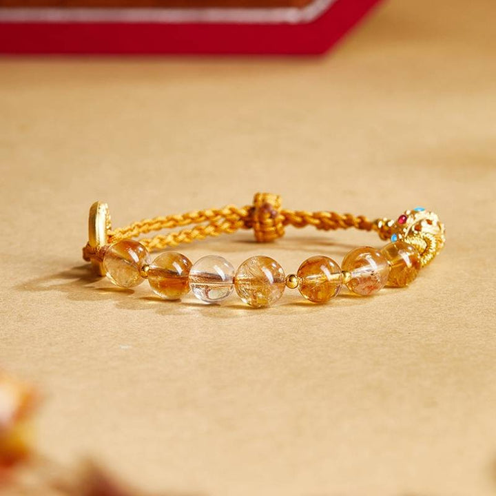 Golden Prosperity Knot Citrine Braided Cord Bracelet With Peace Buckle - staged shot focus on citrine main beads
