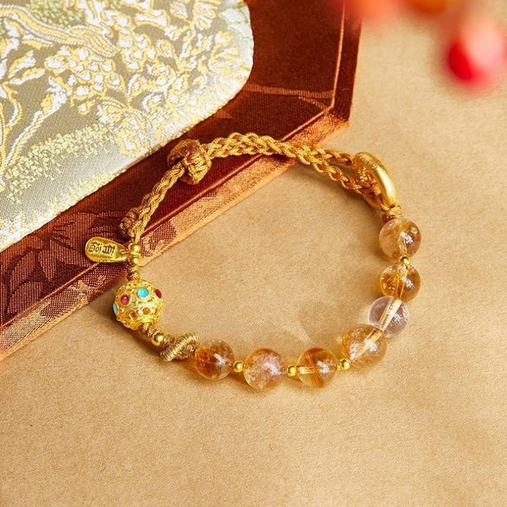 Golden Prosperity Knot Citrine Braided Cord Bracelet With Peace Buckle - prop-styled shot