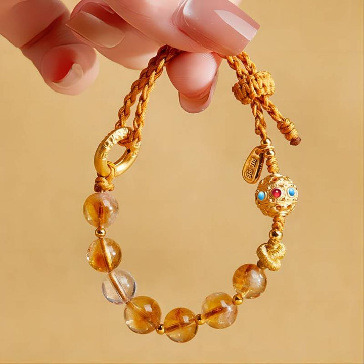 Golden Prosperity Knot Citrine Braided Cord Bracelet With Peace Buckle - on hand shot