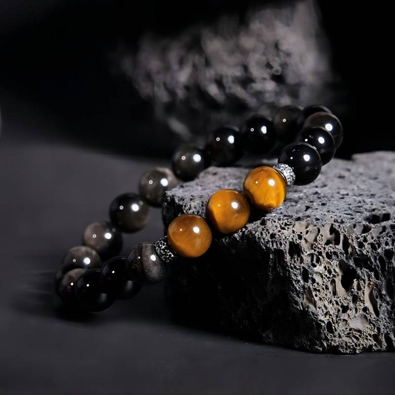 Grounded Confidence And Attract Wealth Bead Bracelet - Side view Staged shot of obsidian and tiger eye bracelet