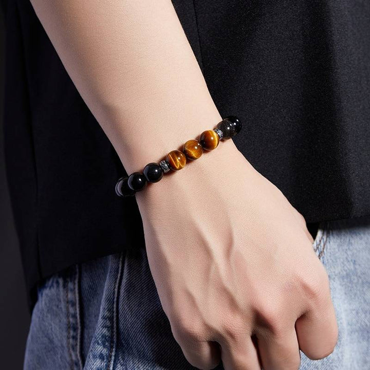 Grounded Confidence And Attract Wealth Bead Bracelet - On wrist shot of obsidian and tiger eye bracelet