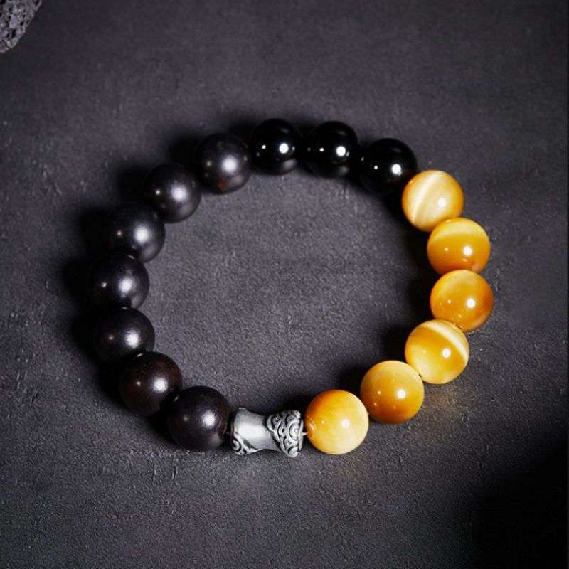 Grounded Confidence And Attract Wealth Bead Bracelet  - Staged shot of black obsidian and tiger eye bracelet