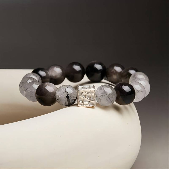 Grounded Confidence Bead Bracelet – prop-styled shot with silver sheen obsidian and black rutilated quartz