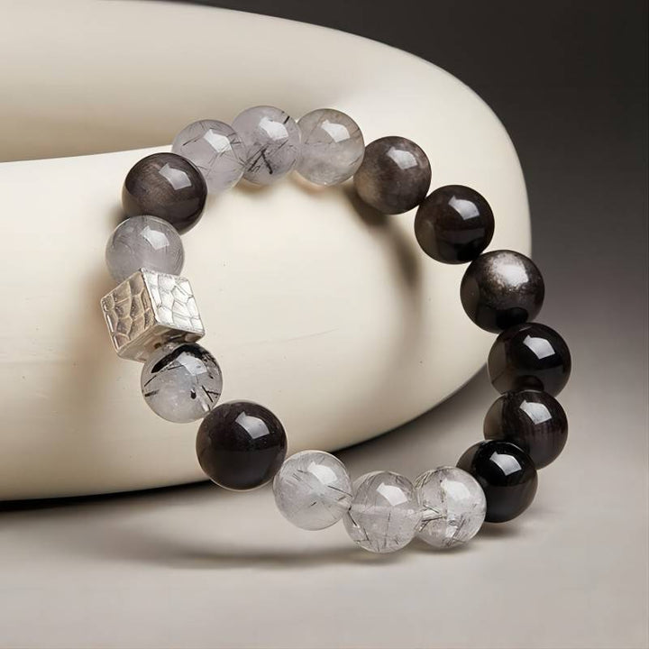 Grounded Confidence Bead Bracelet - side view prop-styled shot with silver sheen obsidian and black rutilated quartz
