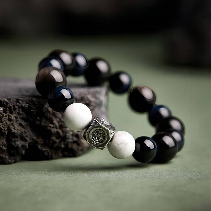 Grounded Confidence Bead Bracelet - Protection &amp; Serenity - Side view prop styling shot of black obsidian bracelet