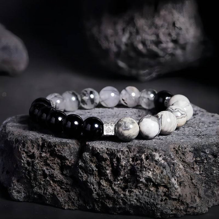 Grounded Confidence Cube Charm Bracelet - Style &amp; Flow - Prop styling shot of black obsidian black rutilated quartz bracelet