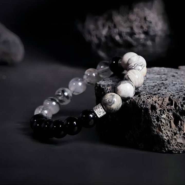 Grounded Confidence Cube Charm Bracelet - Side view staged shot of black obsidian black rutilated quartz bracelet