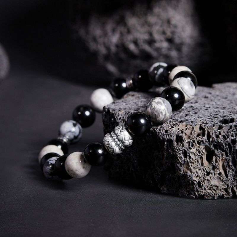 Grounded Elegance Bead Bracelet - Side view staged shot of black obsidian and map stone  bracelet