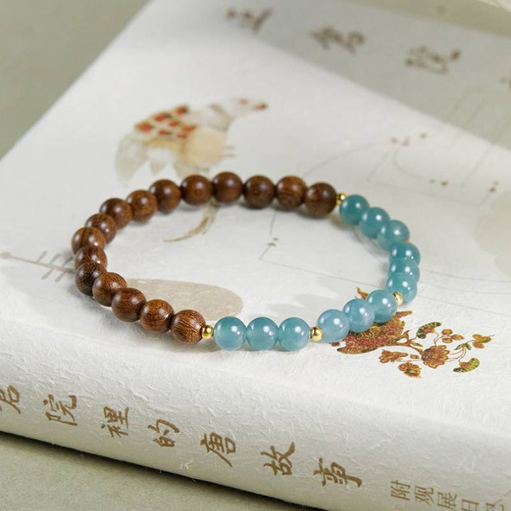 Grounded Harmony Sandalwood And Jadeite Bead Bracelet - Clarity • Prosperity • Spirituality - prop-styled shot