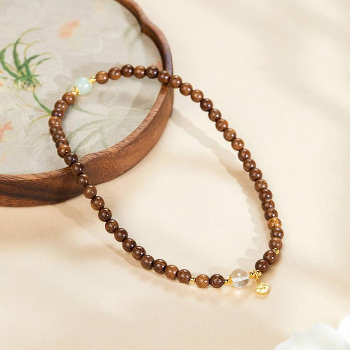 Grounded Harmony Double Wrap Sandalwood Bracelet With Gold-Plated Ruyi Pendant - Prosperity &amp; Clarity - side view shot