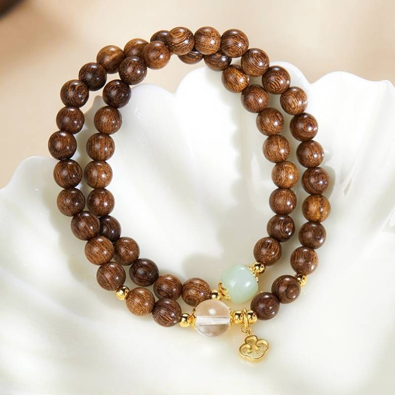 Grounded Harmony Double Wrap Sandalwood Bracelet With Gold-Plated Ruyi Pendant - Prosperity & Clarity - top view staged shot