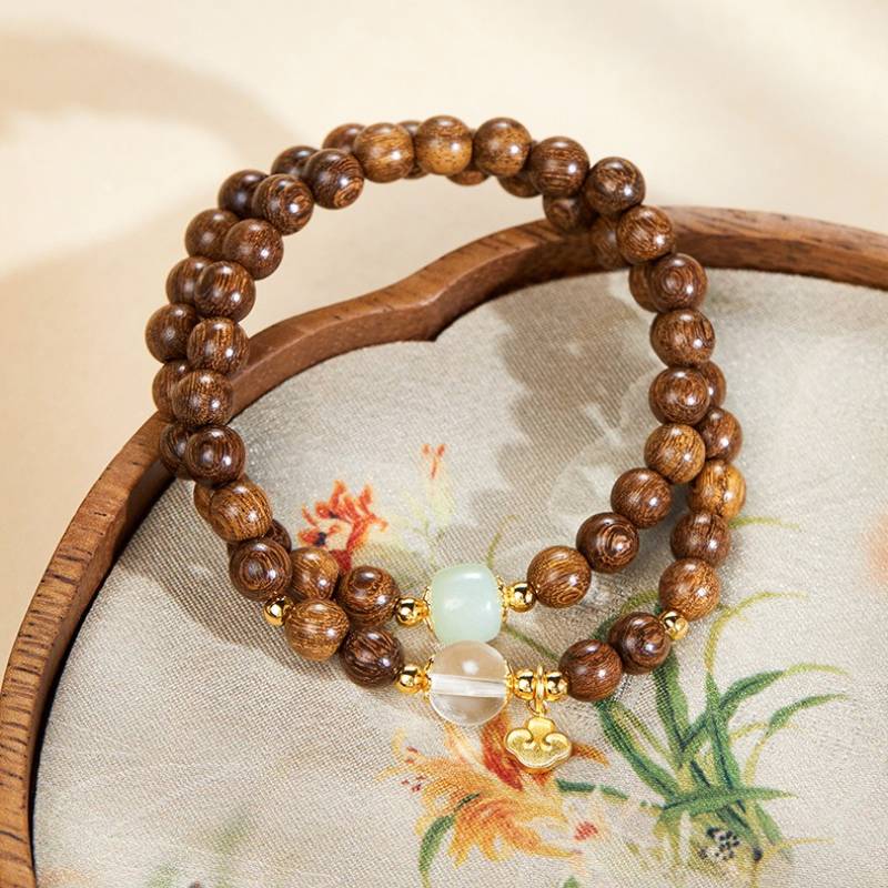 Grounded Harmony Double Wrap Sandalwood Bracelet With Gold-Plated Ruyi Pendant - Prosperity & Clarity - prop-styled shot