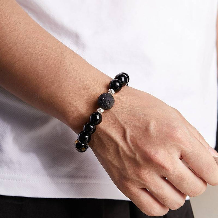 Grounded Mantra Bracelet - On wrist wearing displa of black obsidian bracelet with obsidian meteorite bead