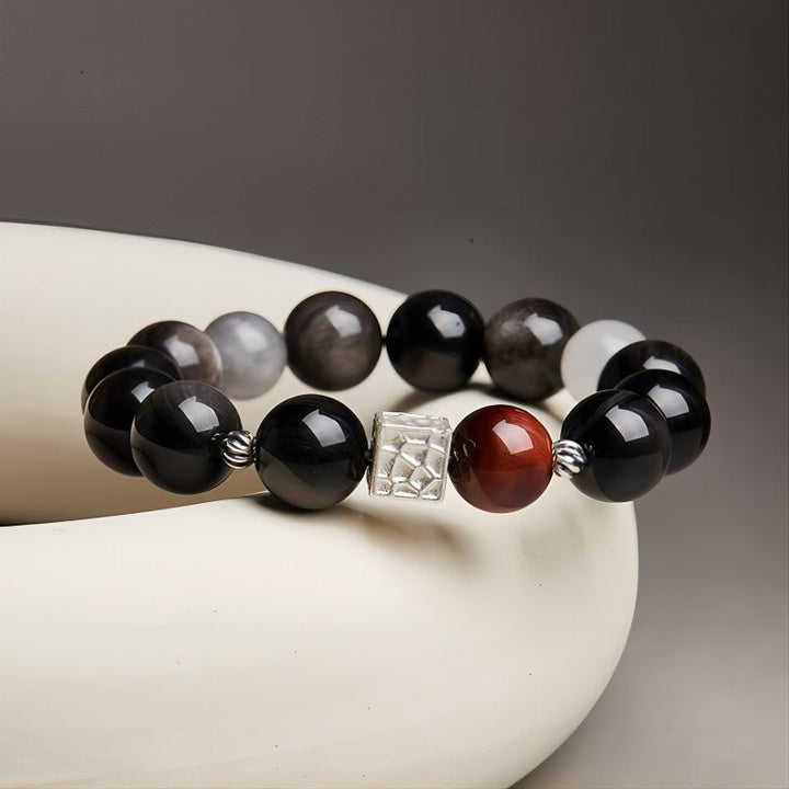 Grounded Power Bead Bracelet - Clarity • Courage • Fortune - Prop styling shot of black obsidian and tiger eye bracelet
