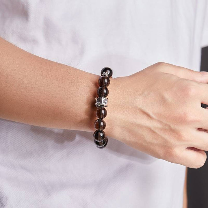 Grounded Protection Bead Bracelet - Calm &amp; Balance - On wrist shot of black bosidian and sandalwood bracelet