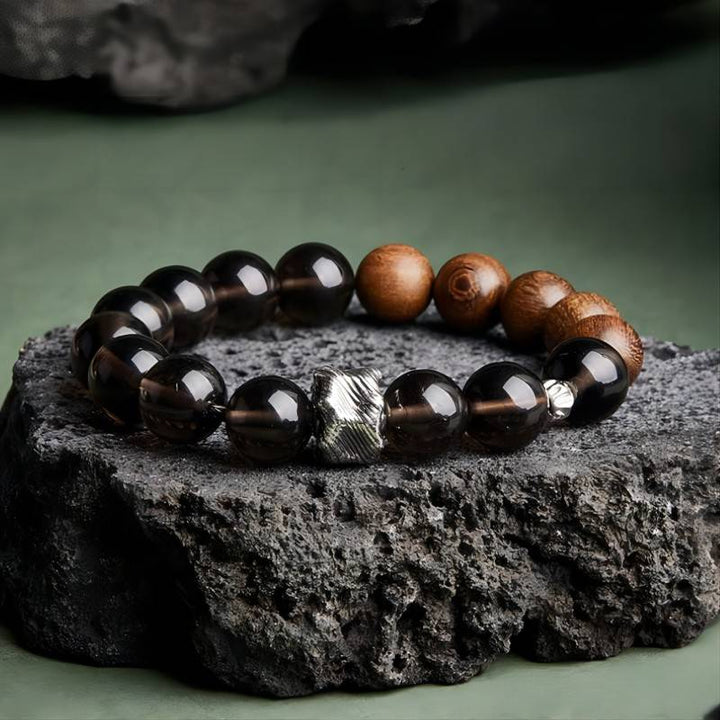 Grounded Protection Bead Bracelet - Calm &amp; Balance - Staged shot of black bosidian and sandalwood bracelet