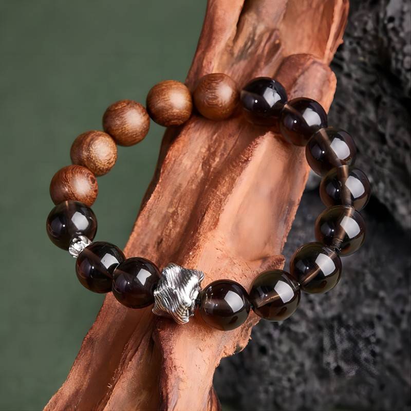 Grounded Protection Bead Bracelet - Calm & Balance - Prop styling shot of black bosidian and sandalwood bracelet