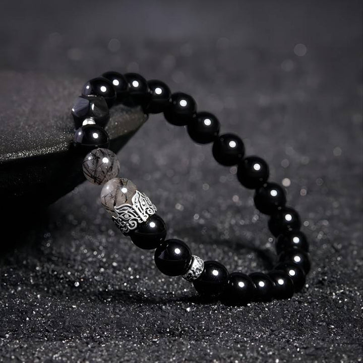 Grounded Protection Black Obsidian Bracelet - Luck &amp; Peace - side view prop-styled shot