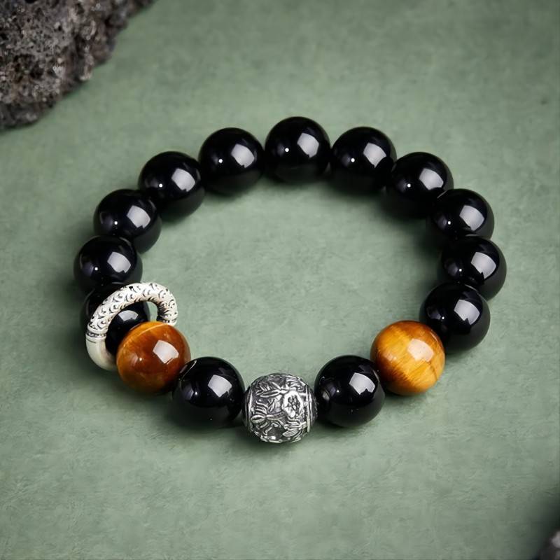 Grounded Protection & Fortune Obsidian Bracelet - Top view staged shot of black obsidian and tiger eye bracelet