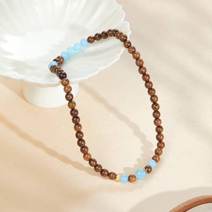 Grounded Serenity Double Wrap Sandalwood And Aquamarine Bracelet - Clarity • Communication • Harmony - prop-styled shot