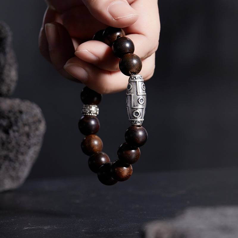 Grounded Wisdom Silver Nine - Eye Dzi Bead Bracelet - Luck &amp; Insight - On hand shot of rosewood bracelet