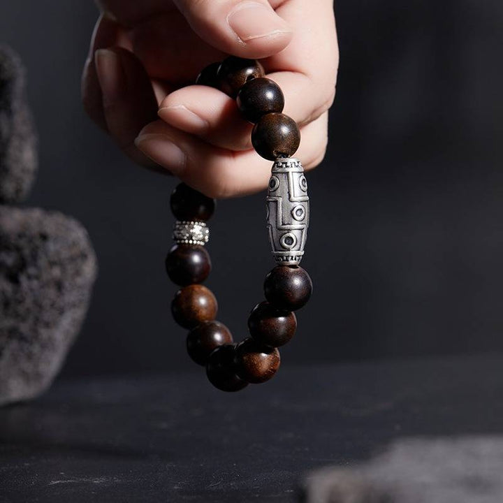 Grounded Wisdom Silver Nine - Eye Dzi Bead Bracelet - Luck &amp; Insight - On hand shot of rosewood bracelet