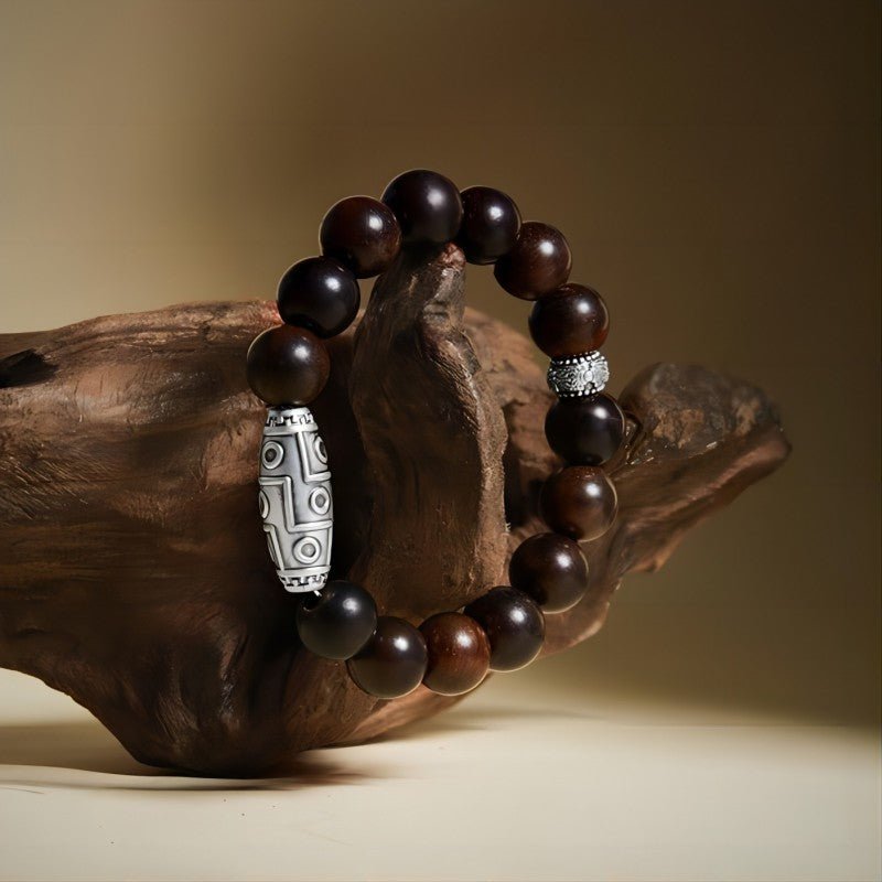 Grounded Wisdom Silver Nine - Eye Dzi Bead Bracelet - Luck &amp; Insight - Side view prop styling shot of rosewood bracelet