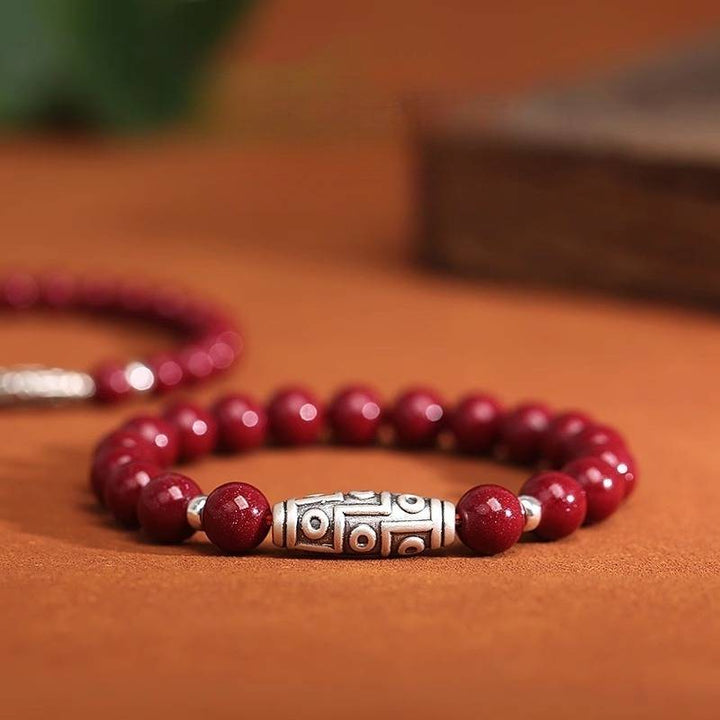 Guardian Auspicious Nine Eyes Dzi Bead Cinnabar Bracelet - Protection, Abundance - close-up shot focus on sliver master bead