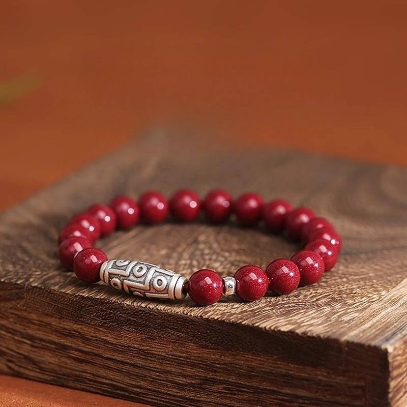 Guardian Auspicious Nine Eyes Dzi Bead Cinnabar Bracelet - Protection, Abundance - prop-styled shot for 6mm bead size