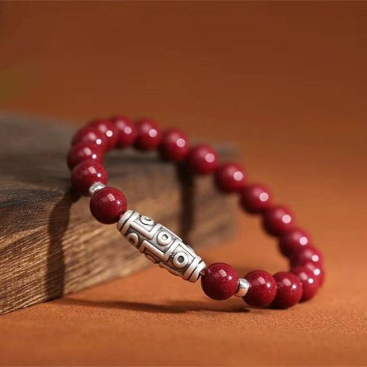 Guardian Auspicious Nine Eyes Dzi Bead Cinnabar Bracelet - Protection, Abundance - prop-styled shot for 8mm bead size