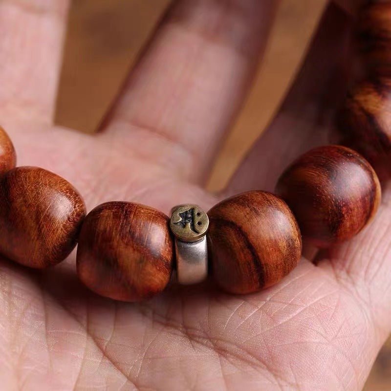 Guardian Sanskrit Zodiac Charm Natural Rosewood Bracelet - Peace &amp; Smooth Fortune - close-up on-hand shot