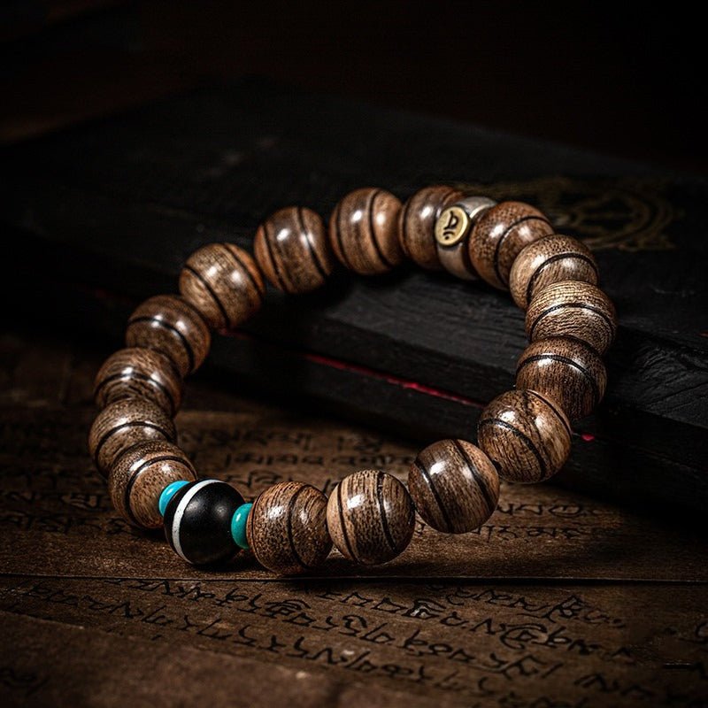 Healing Mantra Protection Bracelet - Vitality & Sacred Guard -  a prop styling shot of the agarwood bracelet